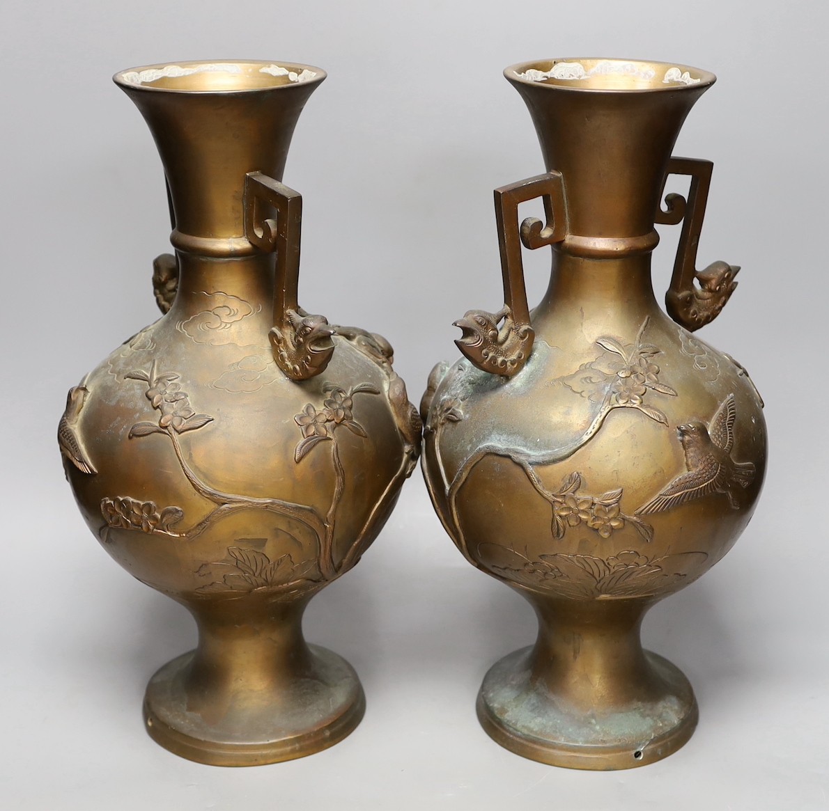 A pair of Japanese two handled bronze vases, 39.5cms high